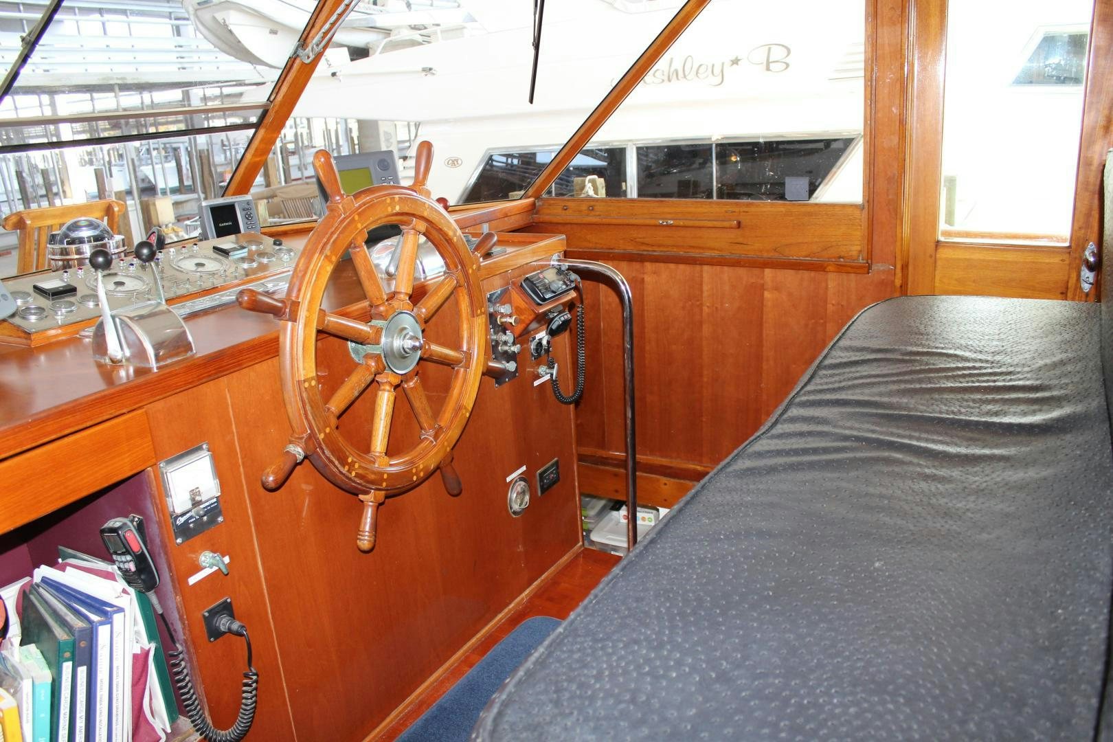 a wooden boat with a steering wheel aboard AMERICA Yacht for Sale