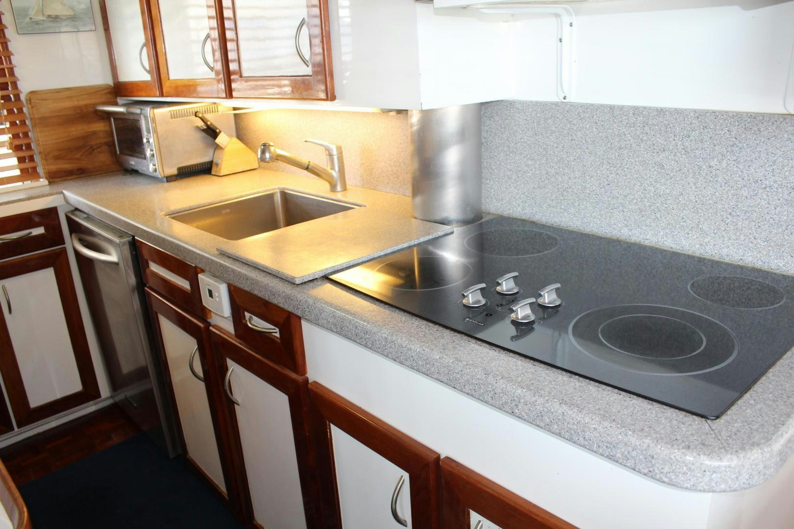 a kitchen with a stove and sink aboard AMERICA Yacht for Sale