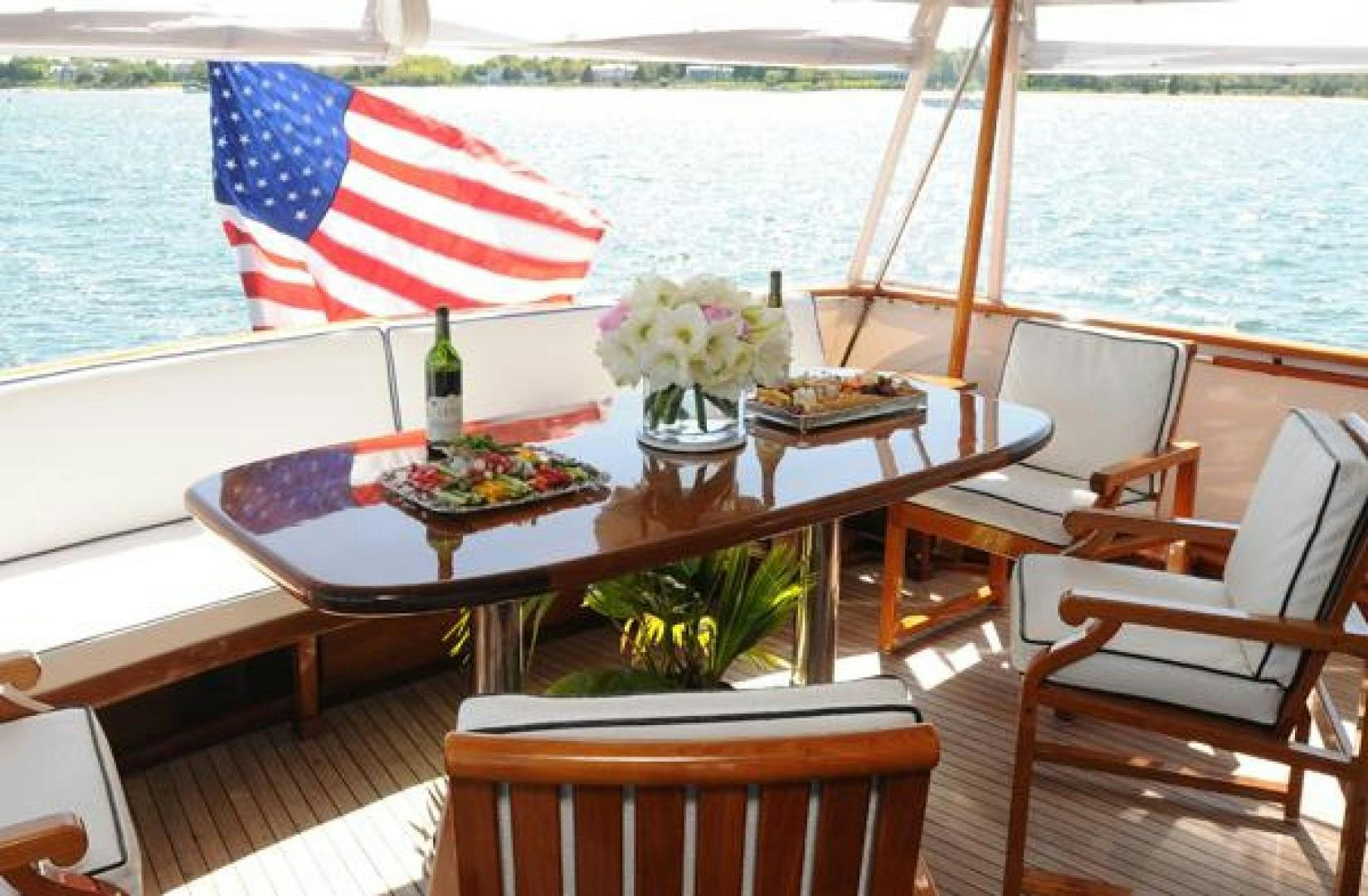 a table with a flag on it aboard AMERICA Yacht for Sale