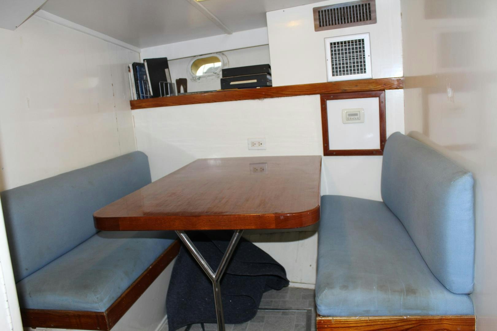 a table and chairs in a room aboard AMERICA Yacht for Sale