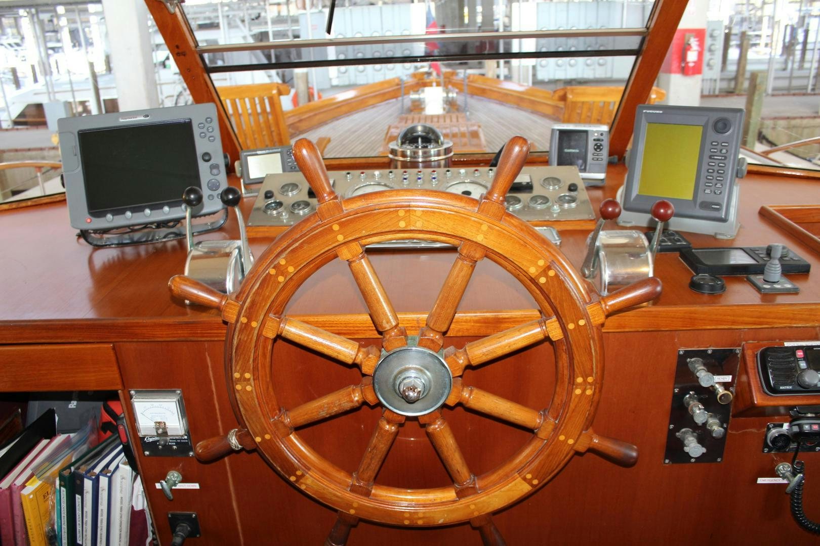 a wooden steering wheel aboard AMERICA Yacht for Sale