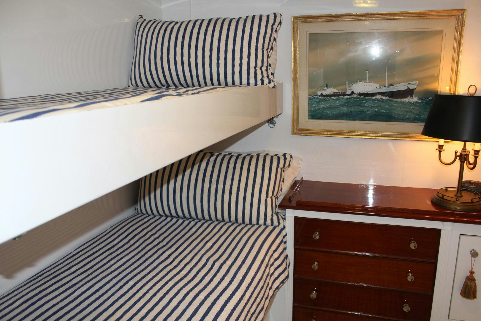 a bedroom with a painting on the wall aboard AMERICA Yacht for Sale