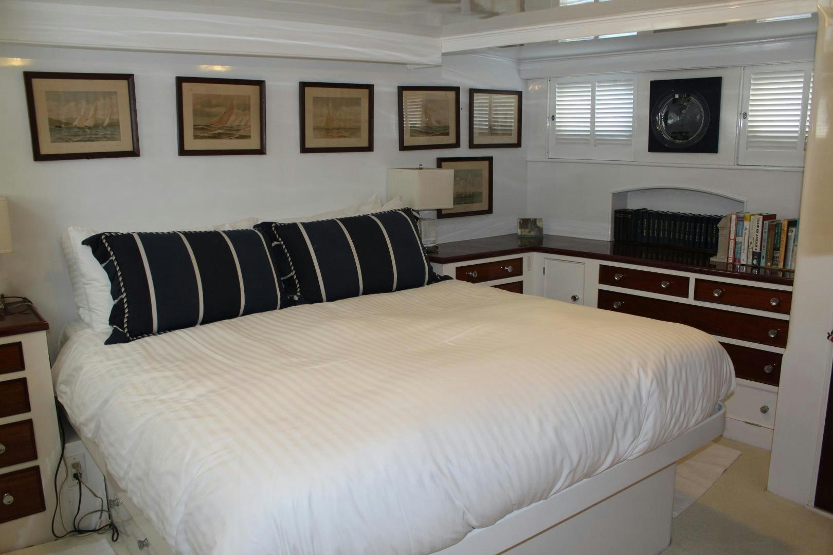 a bed with a couch aboard AMERICA Yacht for Sale