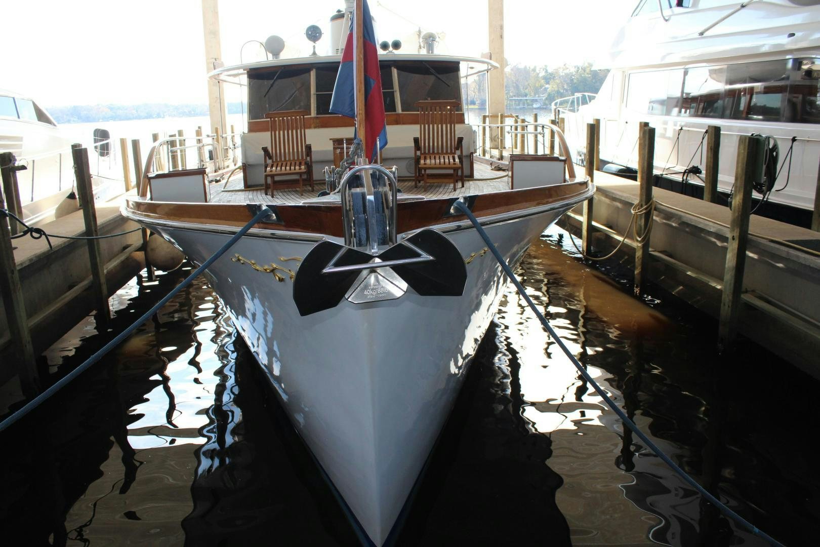 a boat docked at a pier aboard AMERICA Yacht for Sale
