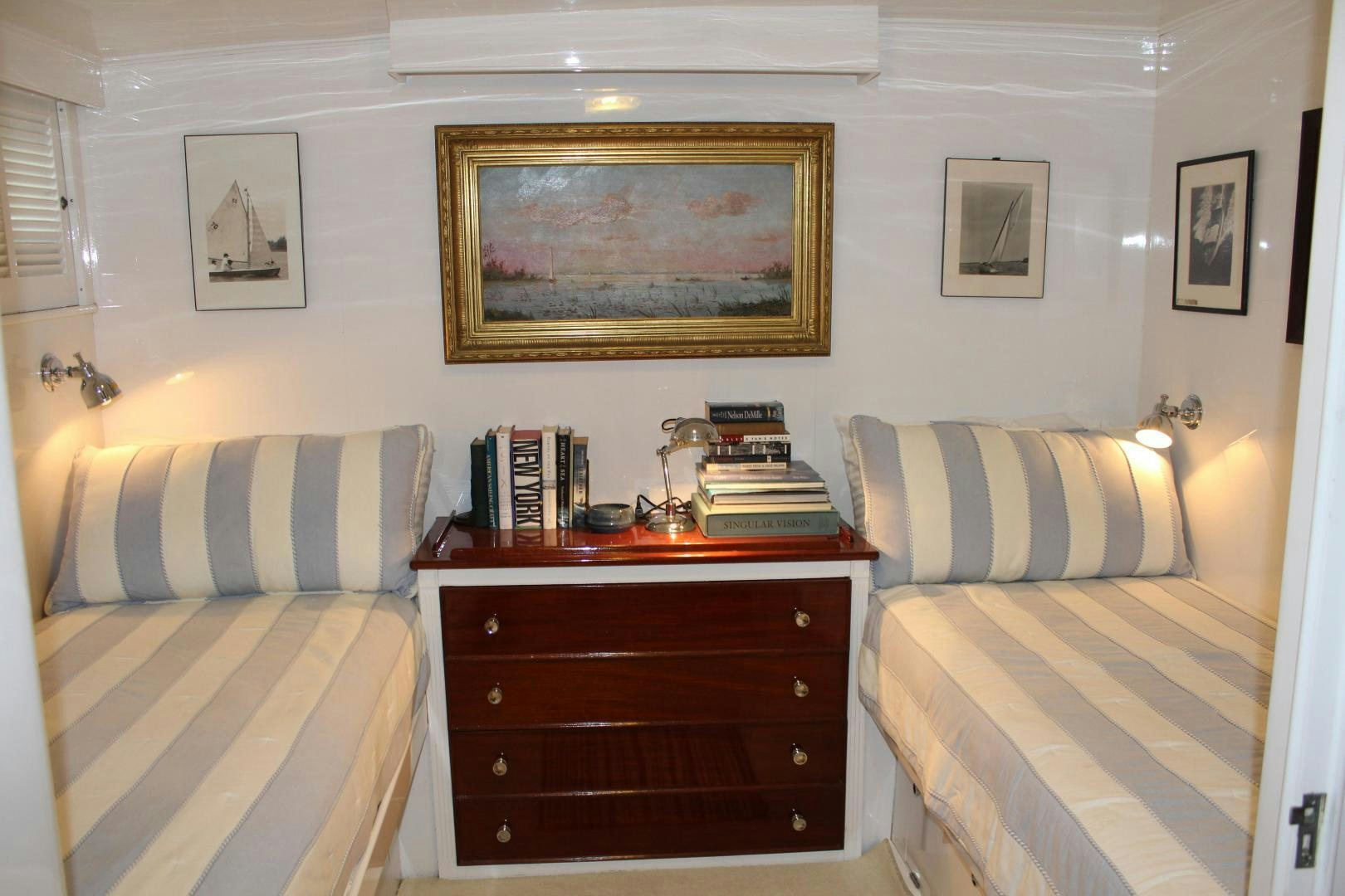 a bedroom with a bed and a desk aboard AMERICA Yacht for Sale