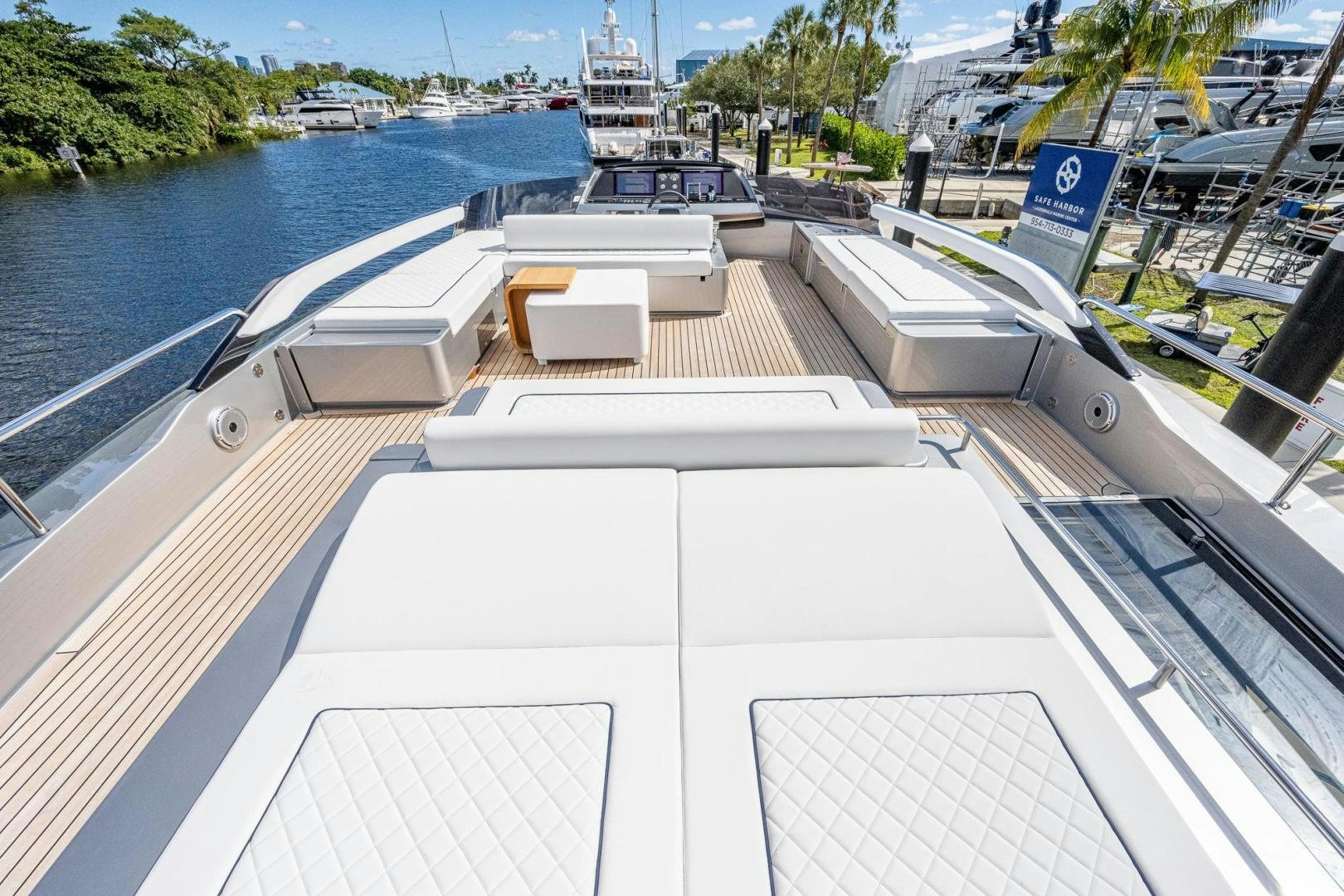 a deck with a deck and a body of water with boats in the background aboard LISOLO Yacht for Sale