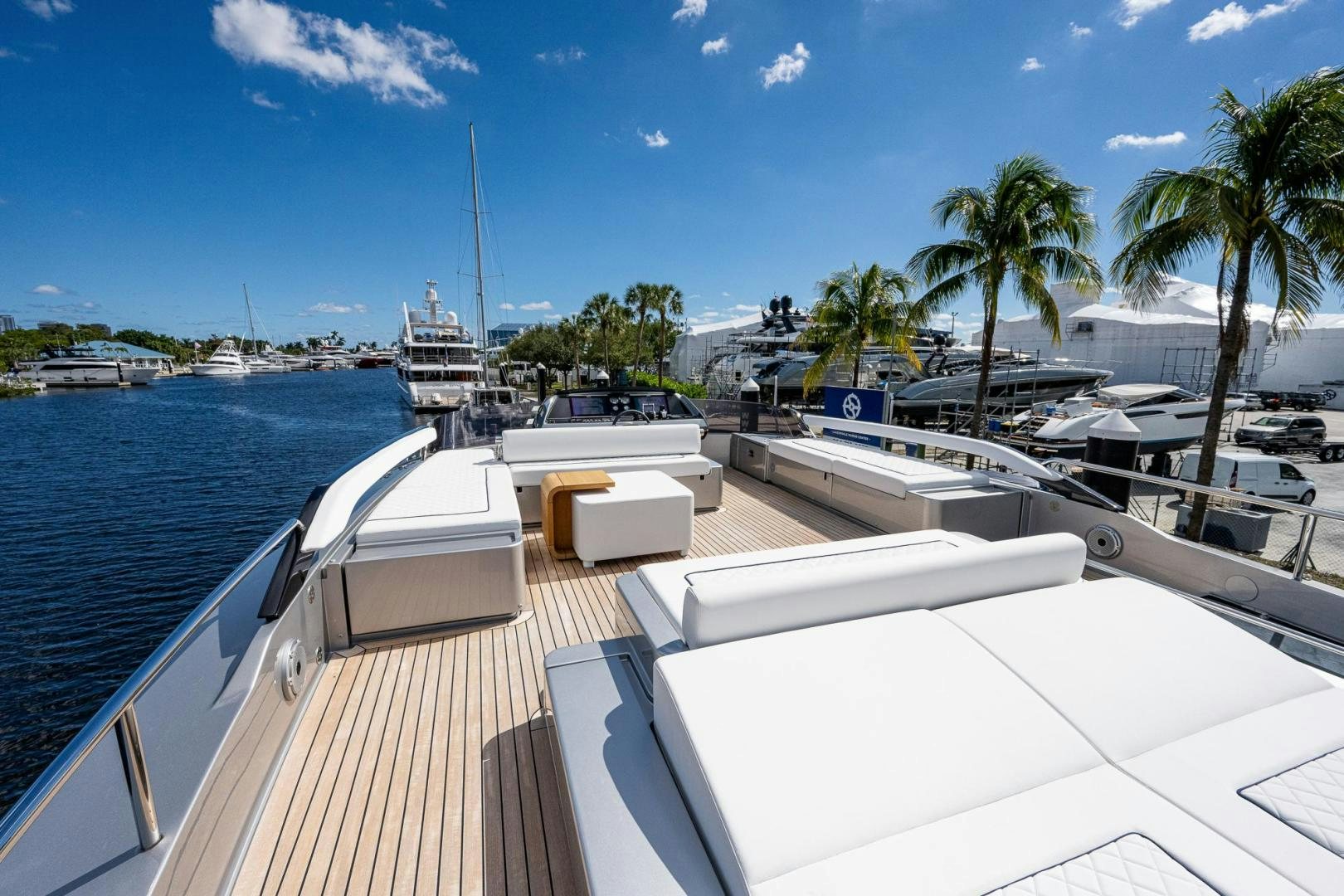a deck with a view of the ocean and boats aboard LISOLO Yacht for Sale