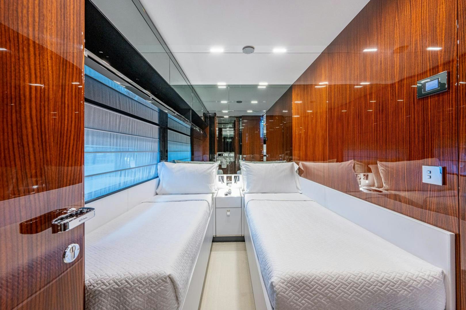 a room with beds and a window aboard LISOLO Yacht for Sale