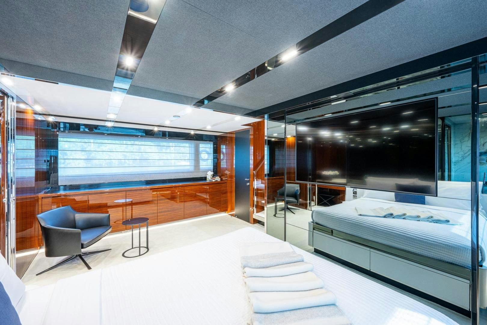 a room with a bed and a chair aboard LISOLO Yacht for Sale