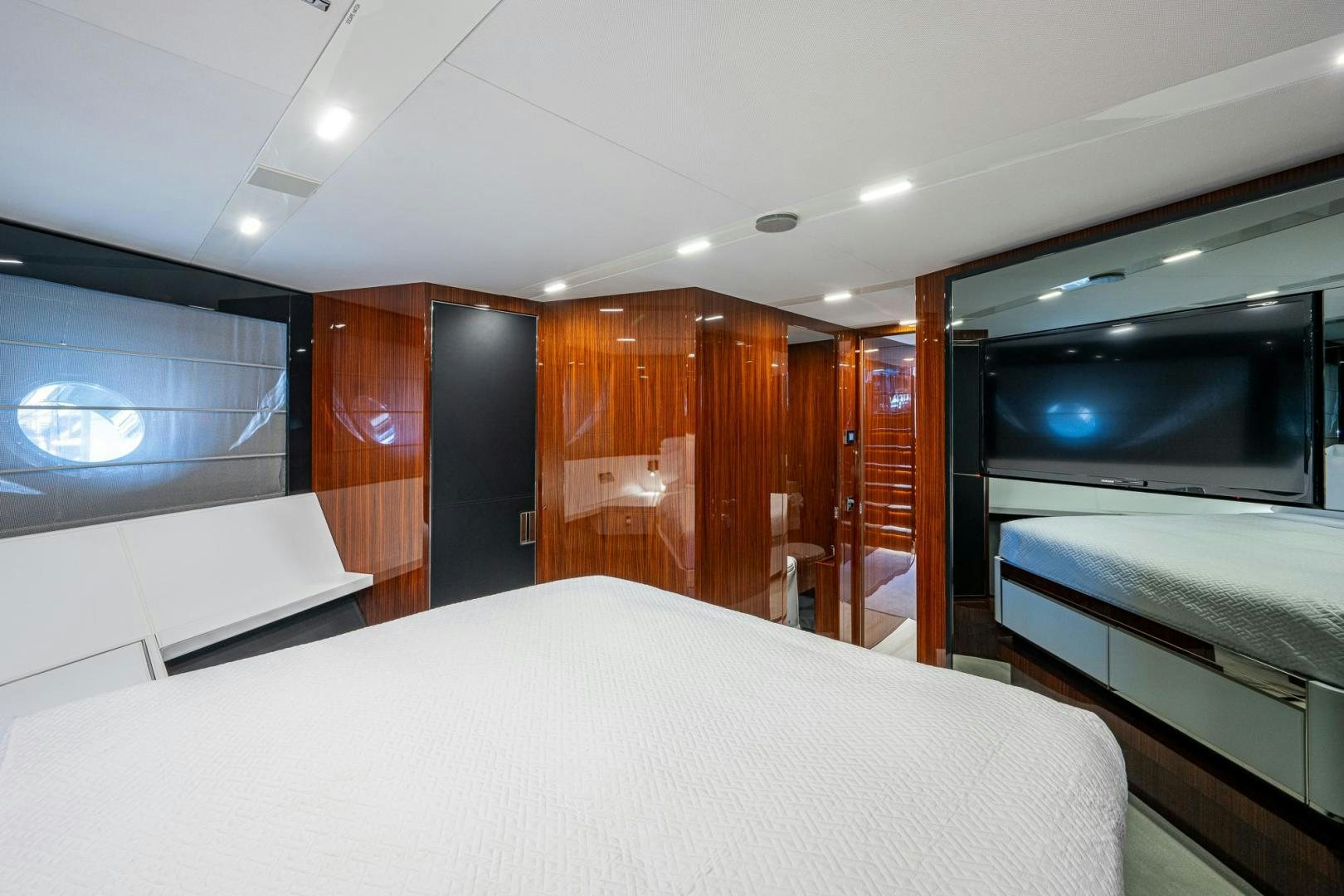 a room with a bed and a television aboard LISOLO Yacht for Sale