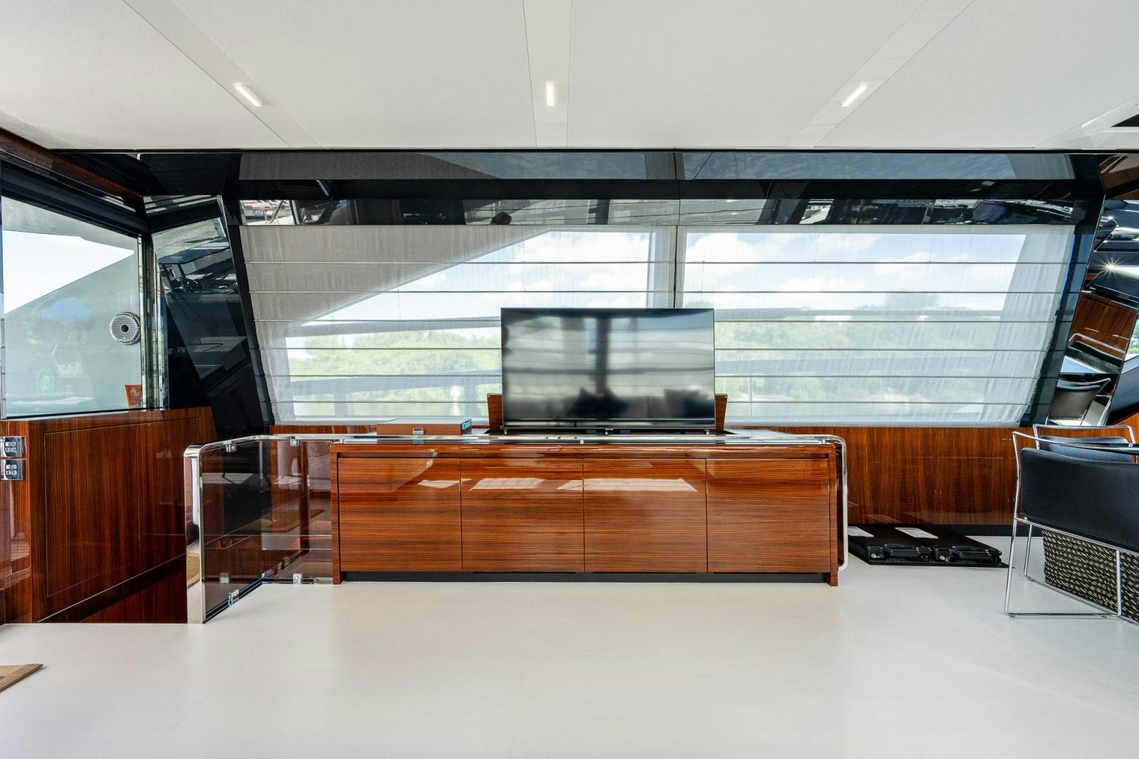 a room with a large window and a desk with a computer on it aboard LISOLO Yacht for Sale