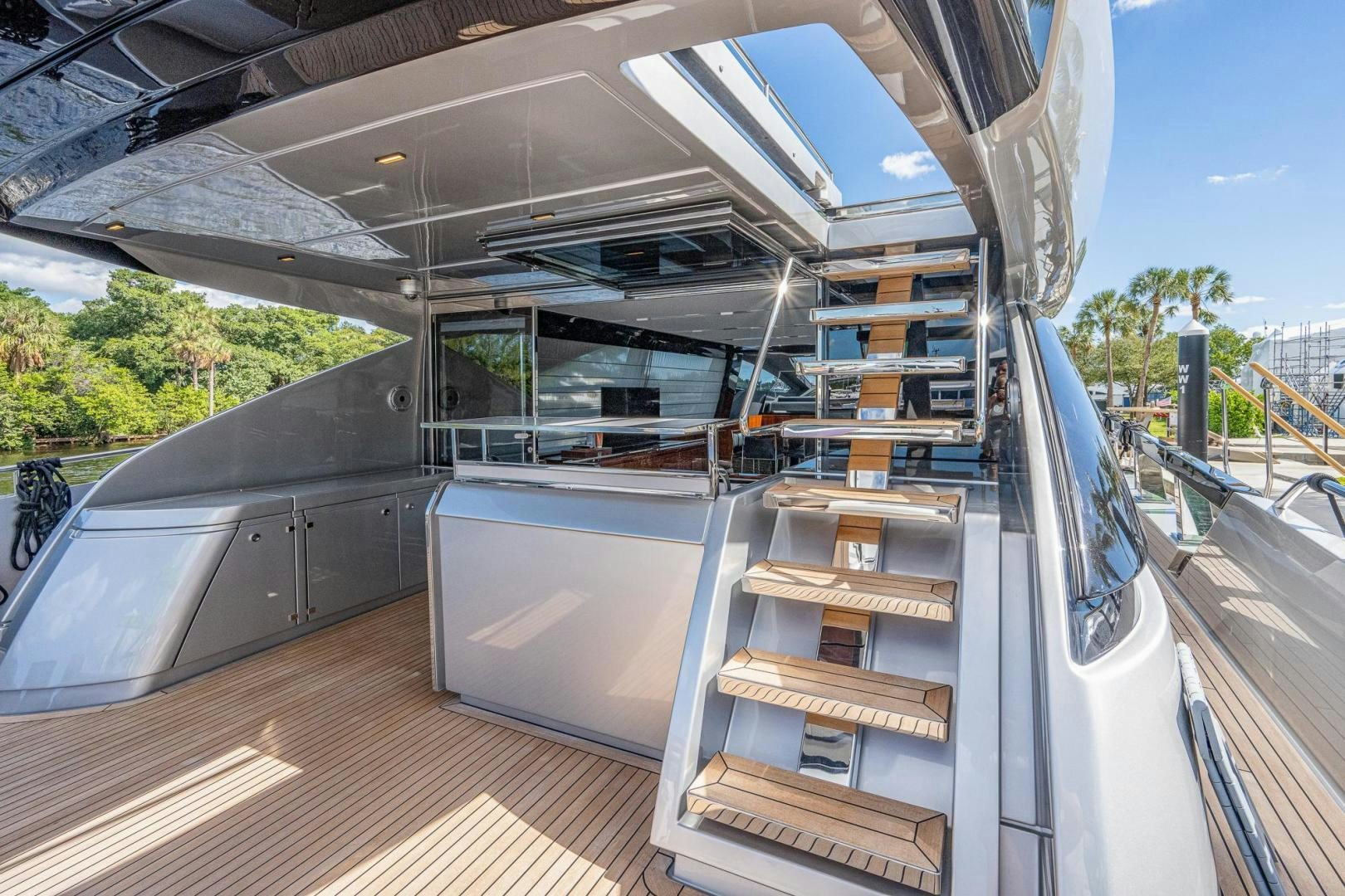 a large white and grey building with a staircase and trees aboard LISOLO Yacht for Sale