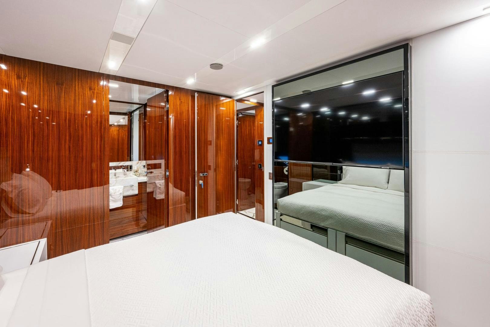 a room with a bed and a mirror aboard LISOLO Yacht for Sale