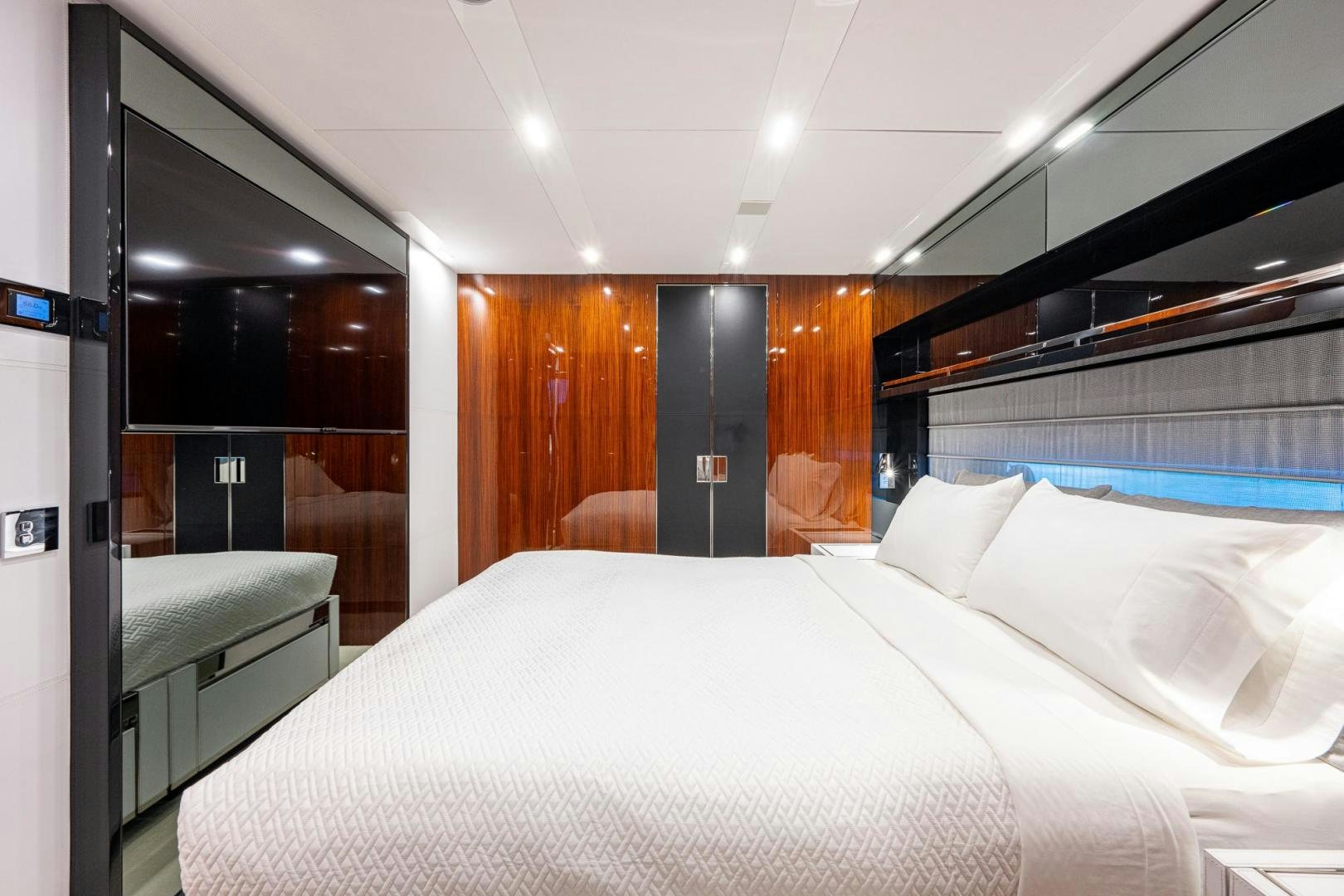 a room with a bed and desk aboard LISOLO Yacht for Sale