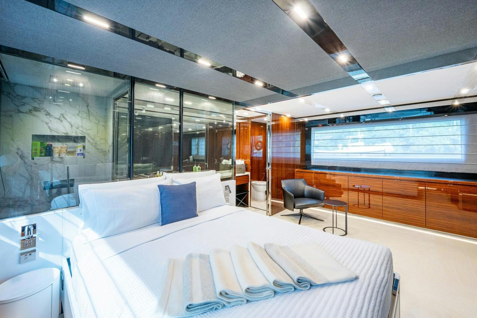 a room with a bed and a chair aboard LISOLO Yacht for Sale