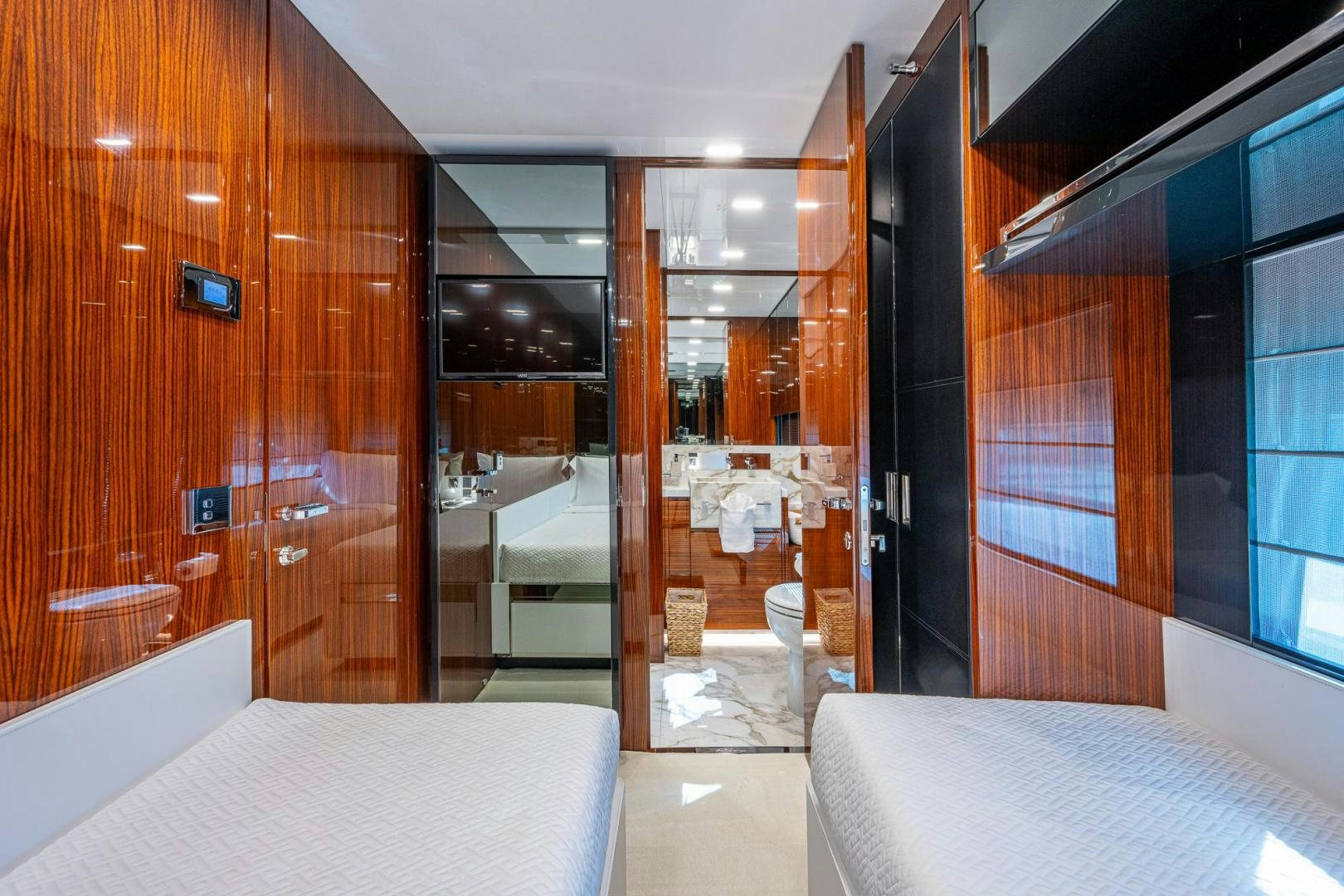 a room with a bed and a glass door aboard LISOLO Yacht for Sale