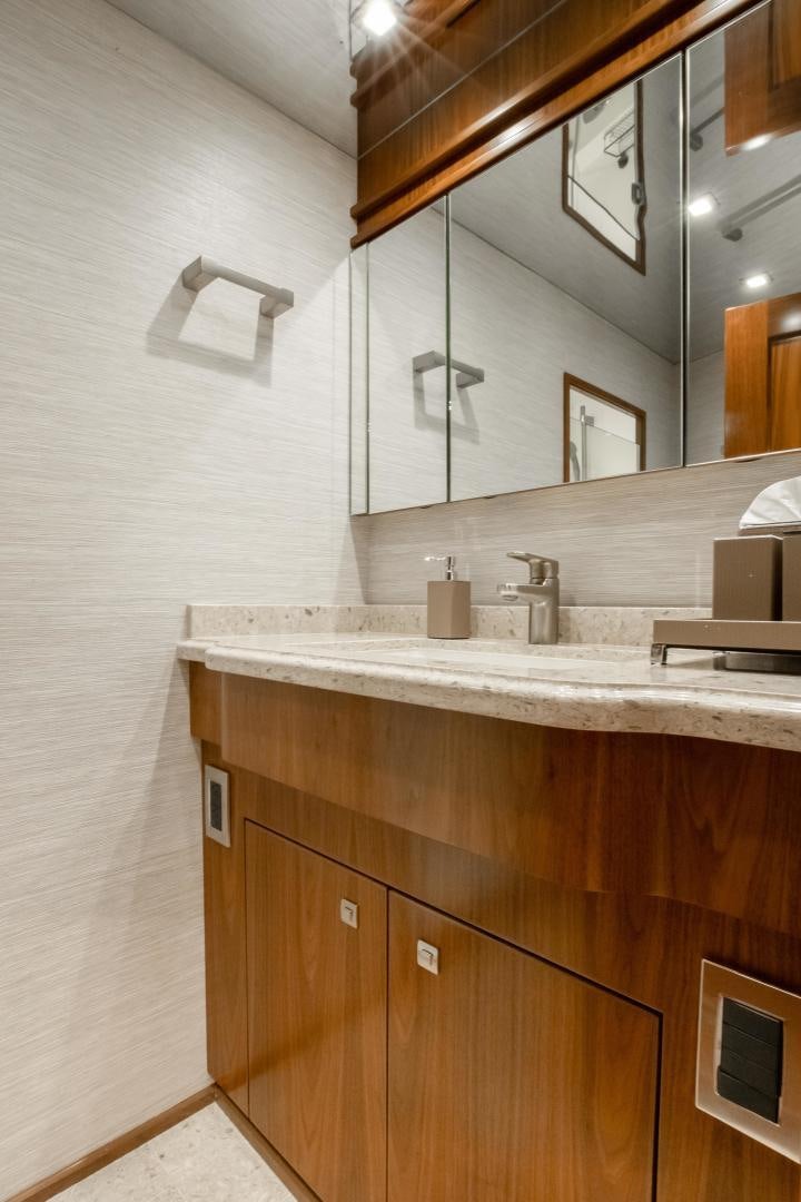 a bathroom with a sink and a mirror aboard POMPINA Yacht for Sale
