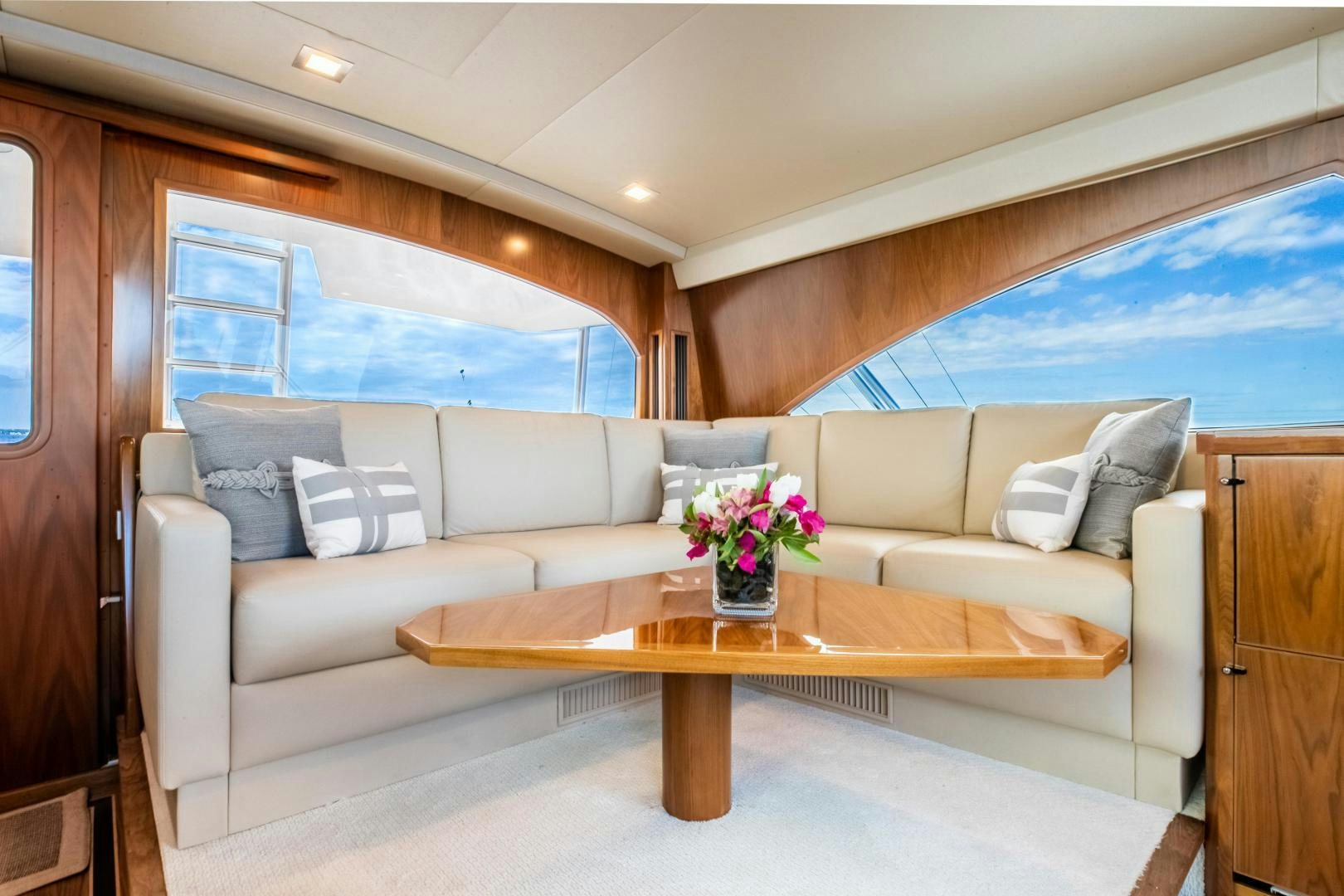 a living room with a couch and a table aboard POMPINA Yacht for Sale