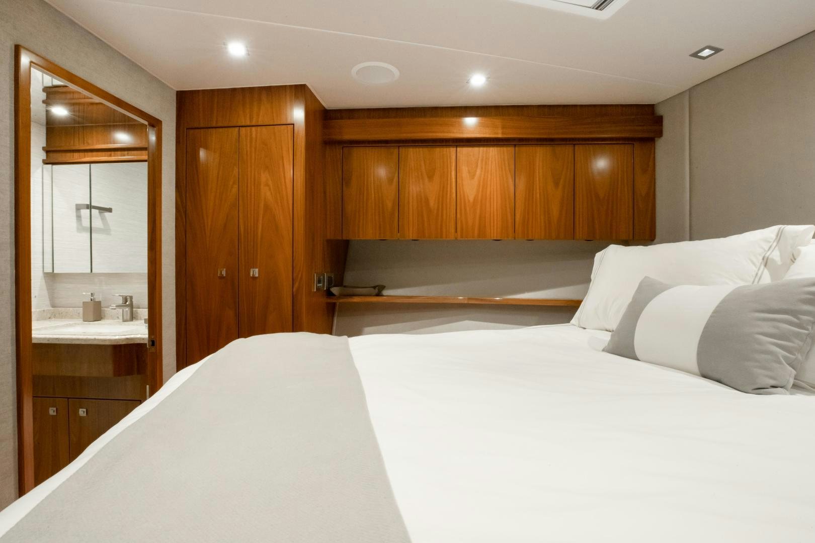 a room with a bed and a mirror aboard POMPINA Yacht for Sale