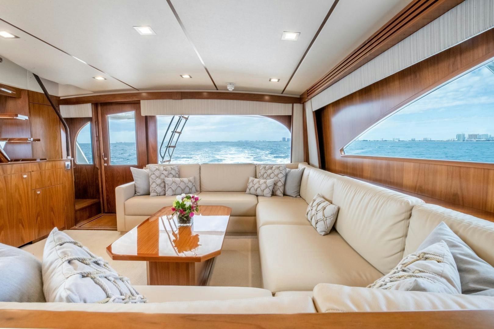 a living room with a large window aboard POMPINA Yacht for Sale