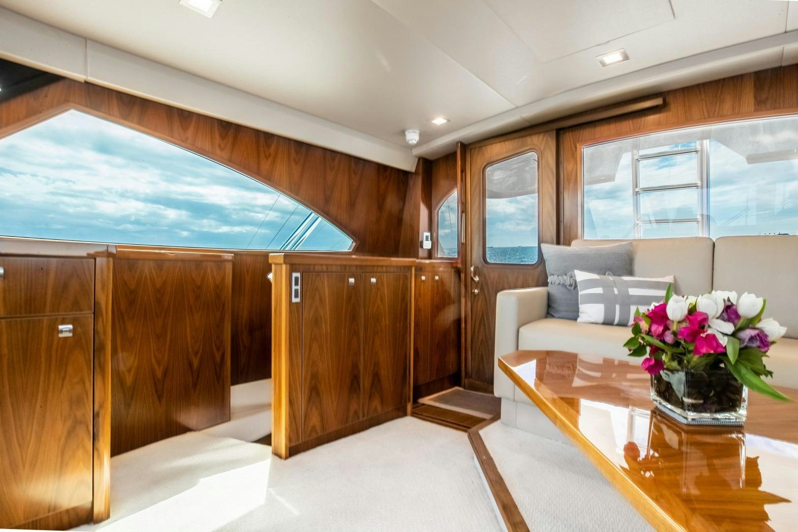 a room with a table and a couch aboard POMPINA Yacht for Sale