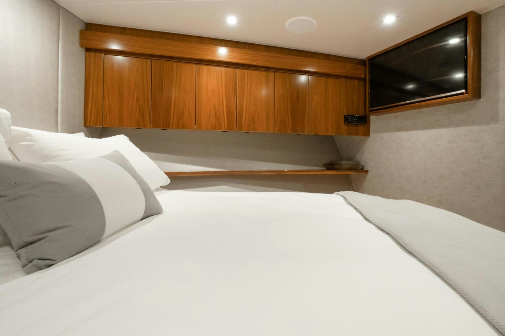 a bed with white sheets aboard POMPINA Yacht for Sale