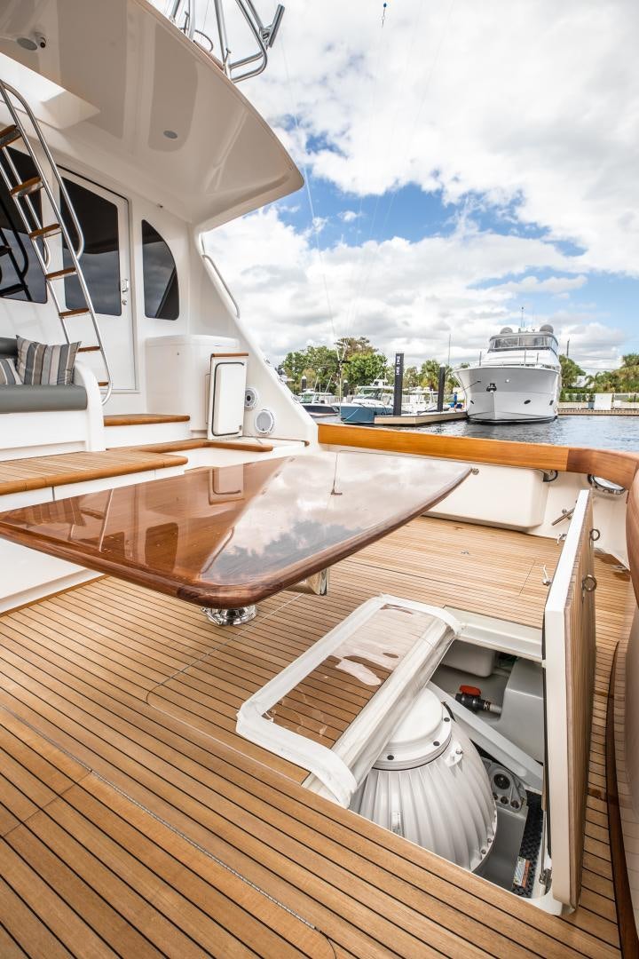 a deck with a boat and a large boat on it aboard POMPINA Yacht for Sale