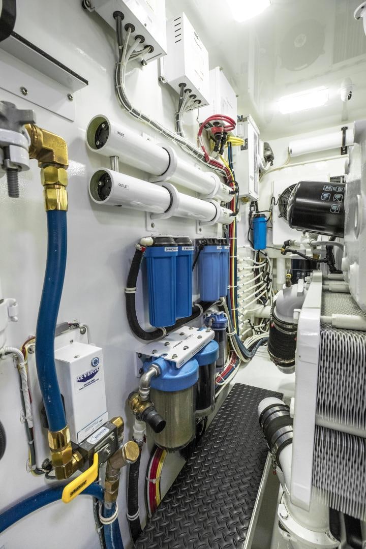 a white machine with blue and yellow wires aboard POMPINA Yacht for Sale