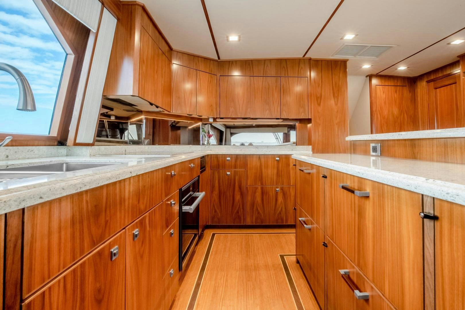 a kitchen with wooden cabinets aboard POMPINA Yacht for Sale