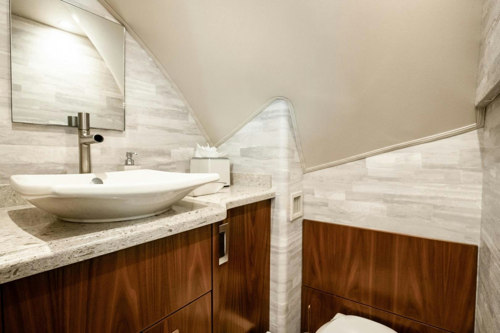 a bathroom with a sink and a mirror aboard POMPINA Yacht for Sale
