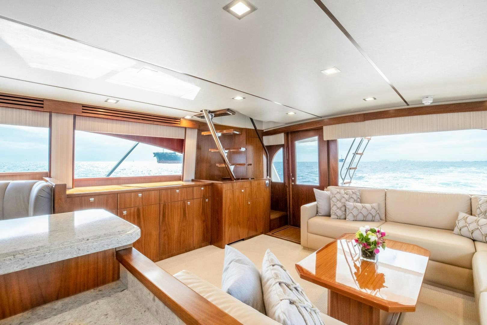 a living room with a couch and a table aboard POMPINA Yacht for Sale