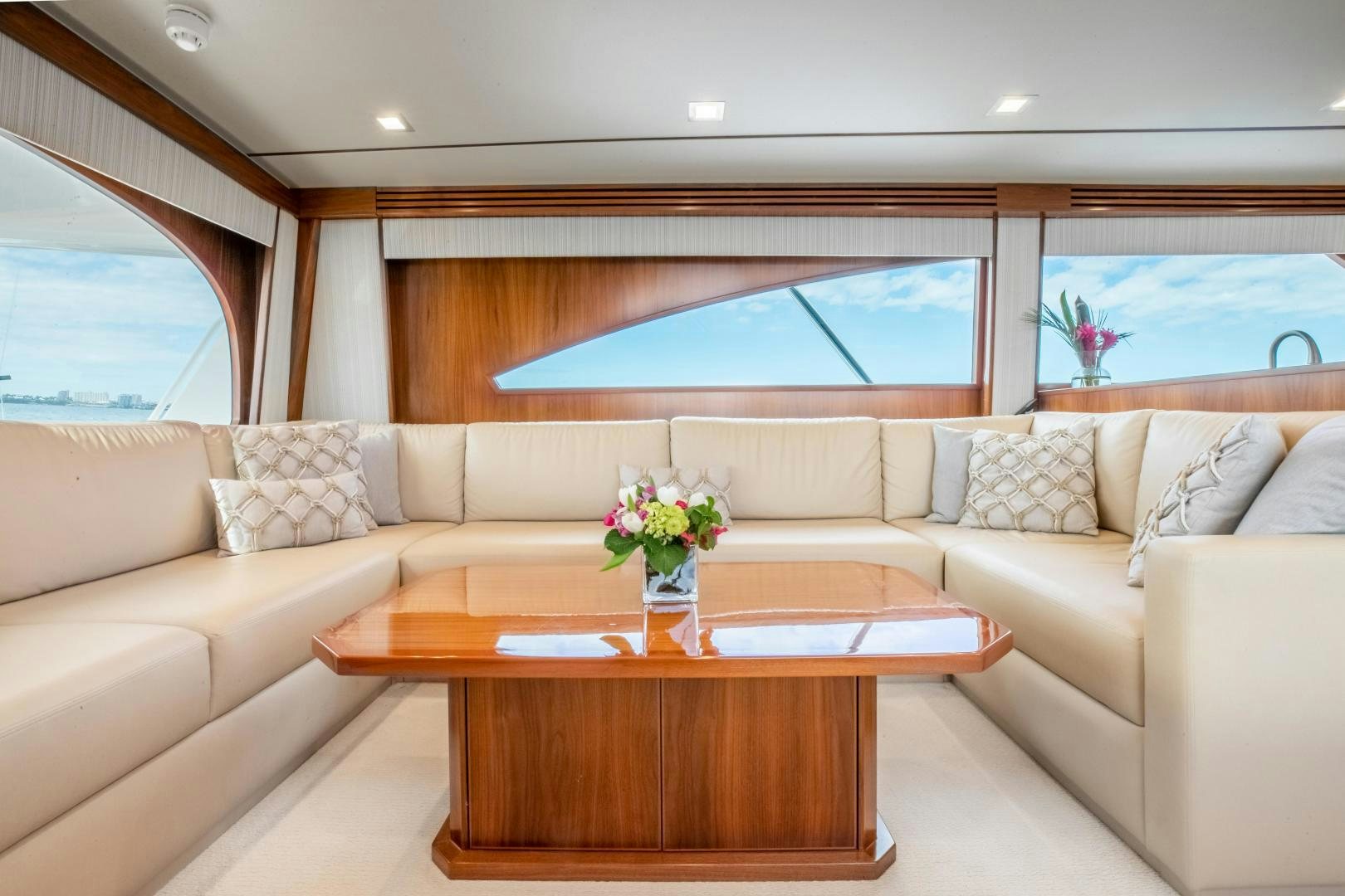 a living room with a table and a couch aboard POMPINA Yacht for Sale