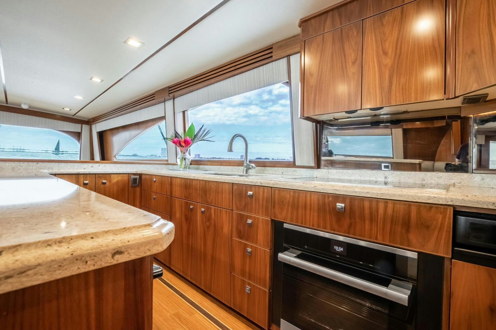 a kitchen with wooden cabinets aboard POMPINA Yacht for Sale