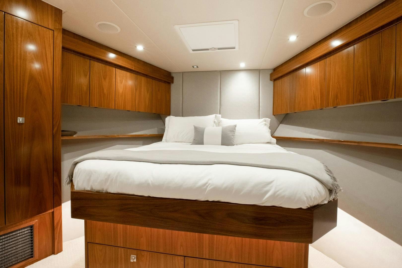a room with a bed and a wood cabinet aboard POMPINA Yacht for Sale