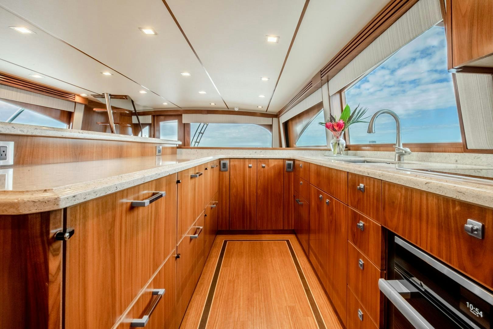 a kitchen with wooden cabinets aboard POMPINA Yacht for Sale