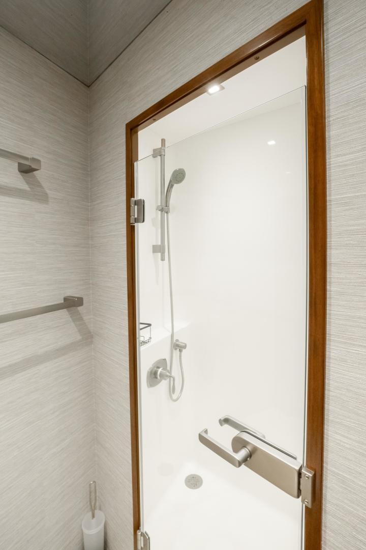 a shower with a glass door aboard POMPINA Yacht for Sale