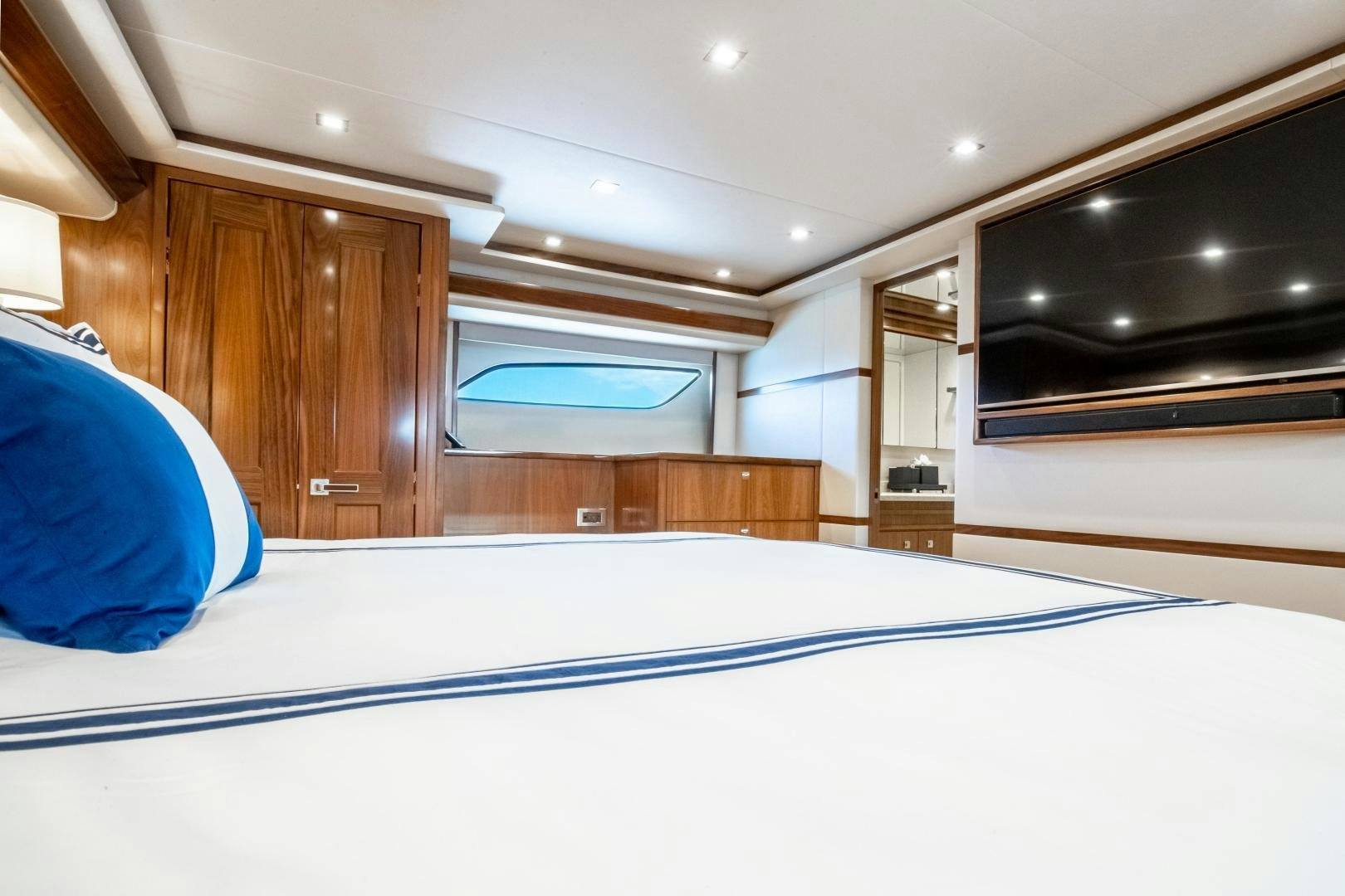 a room with a bed and a television aboard POMPINA Yacht for Sale