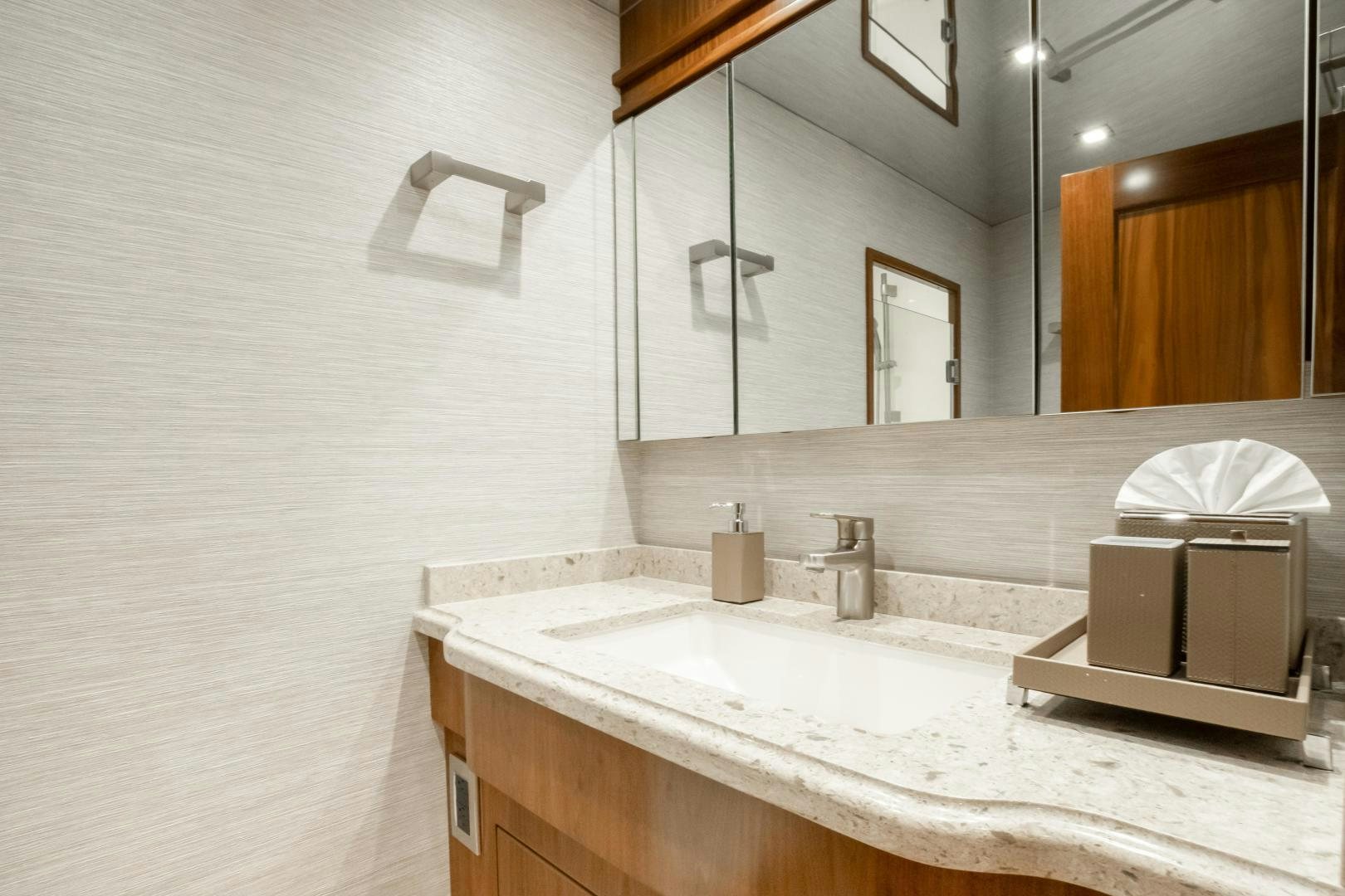 a bathroom with a mirror and a sink aboard POMPINA Yacht for Sale
