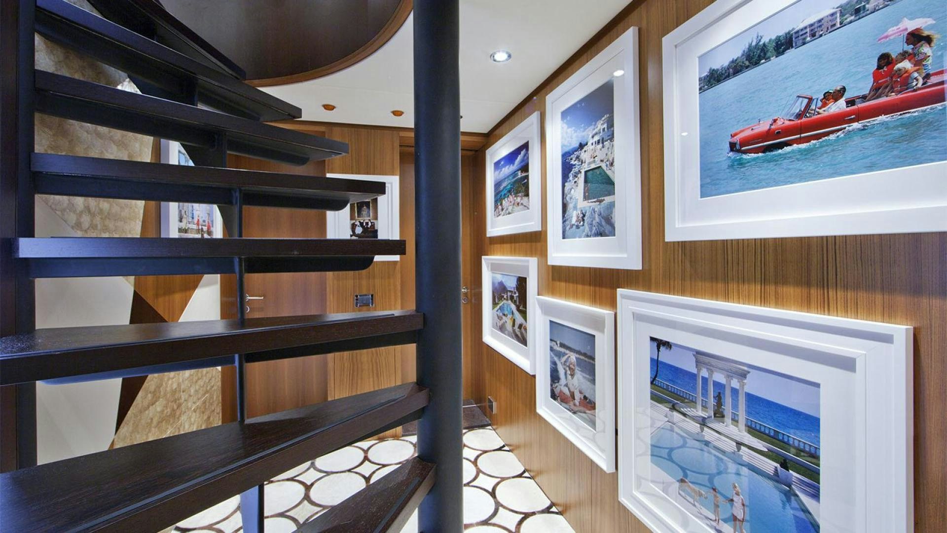 a room with a shelf and pictures on the wall aboard SNOWBIRD Yacht for Sale