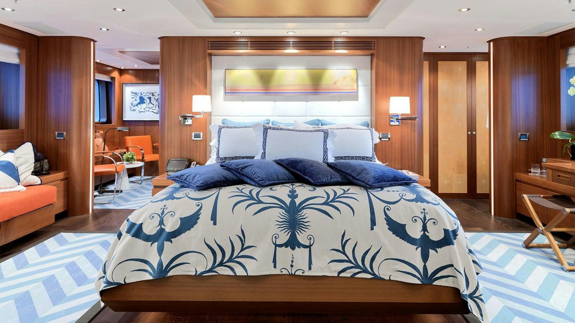 a bed with blue and white sheets aboard SNOWBIRD Yacht for Sale