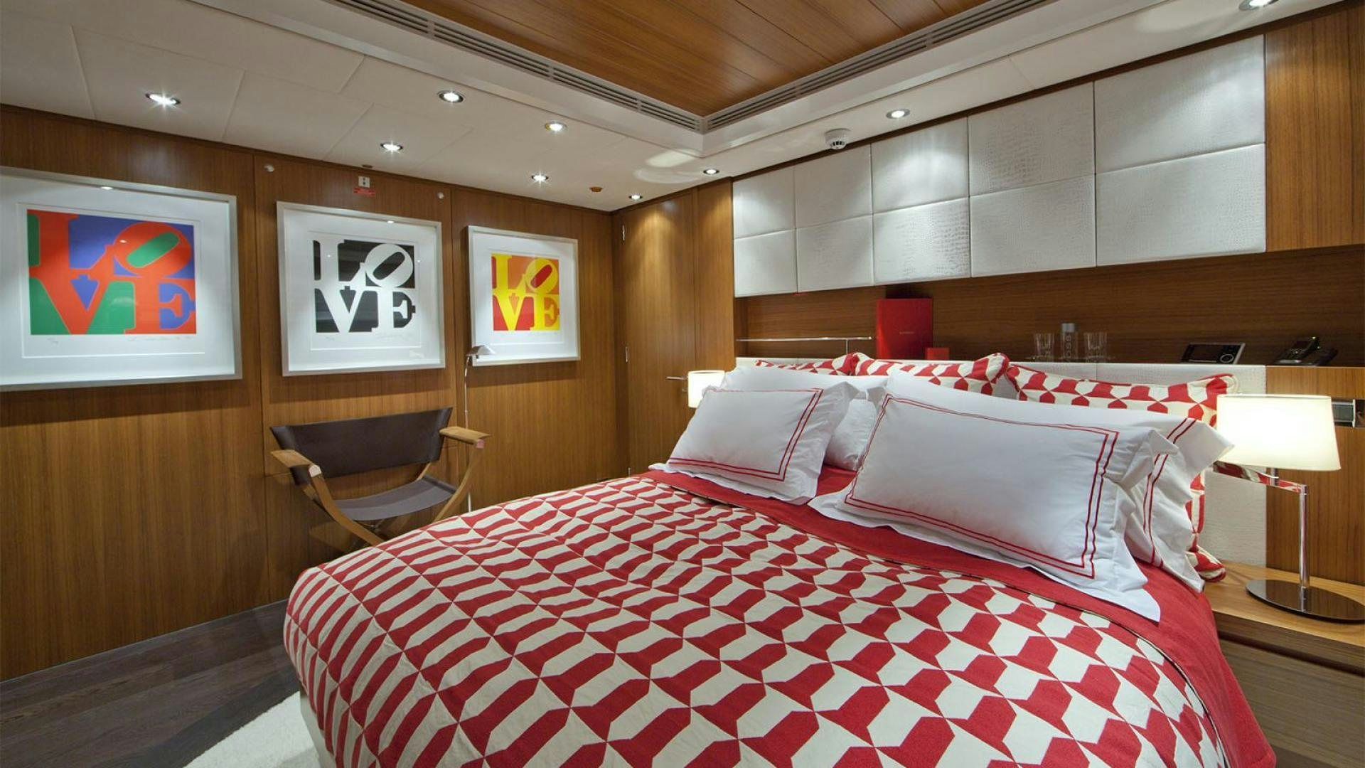 a room with a bed and a chair aboard SNOWBIRD Yacht for Sale
