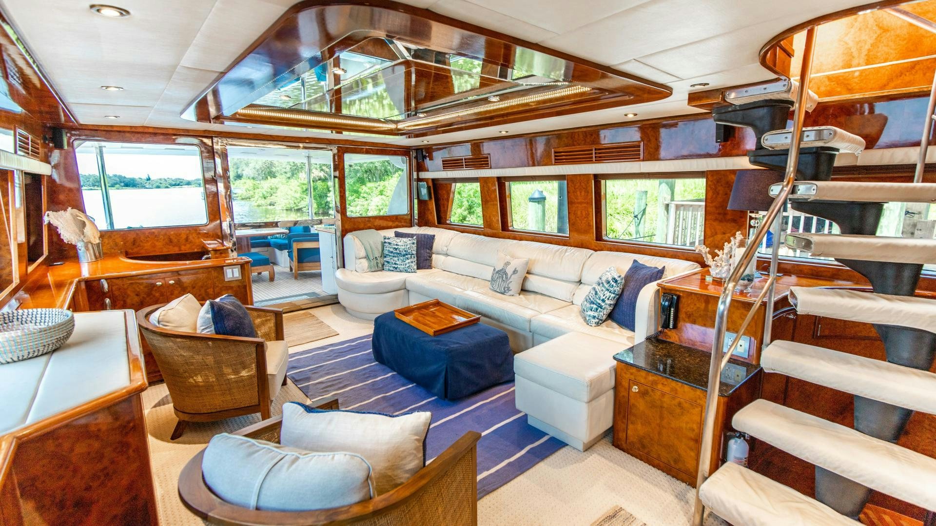 a room with a couch and a table aboard DREAMCHASER Yacht for Sale