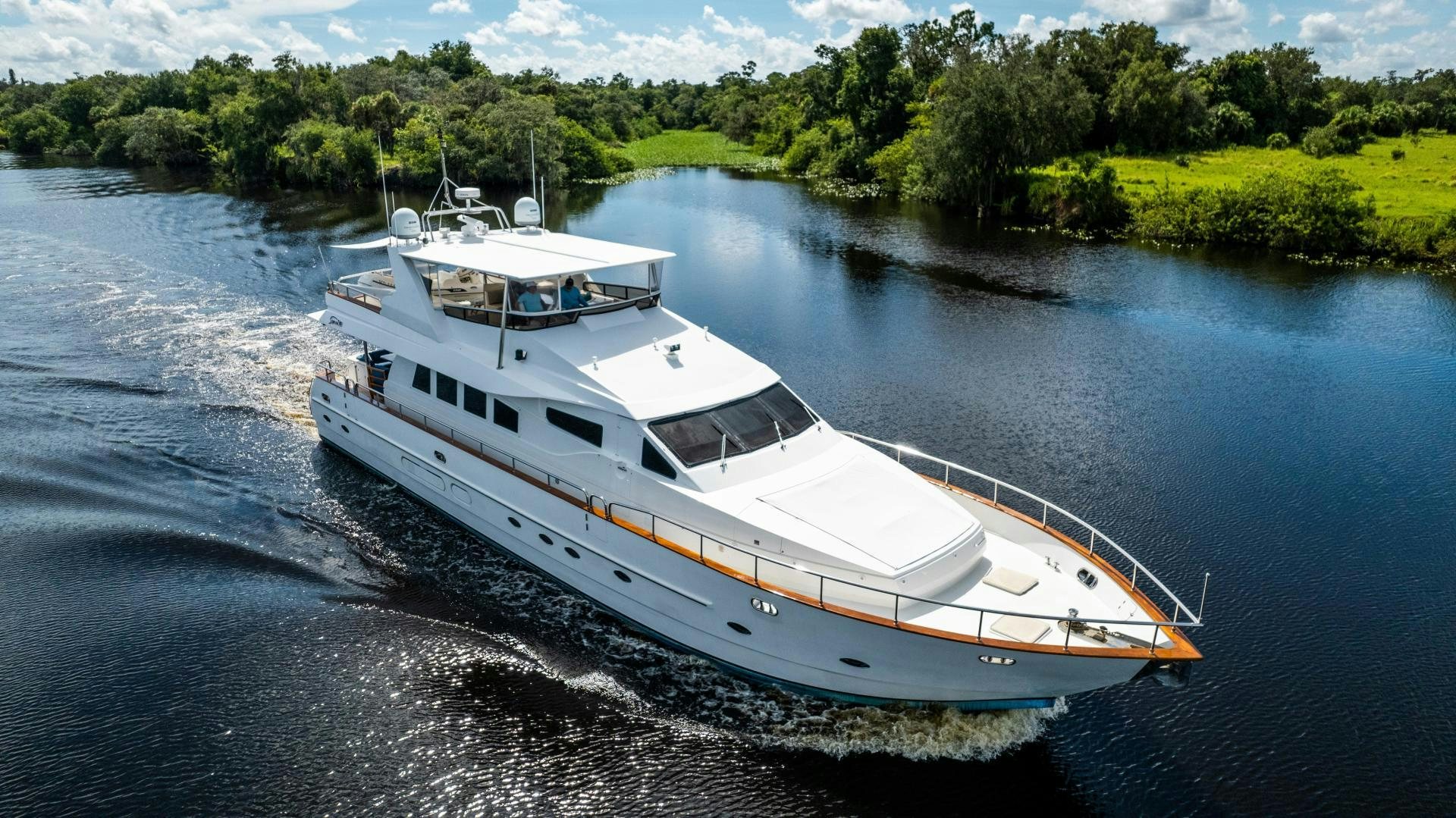 a white boat on water aboard DREAMCHASER Yacht for Sale