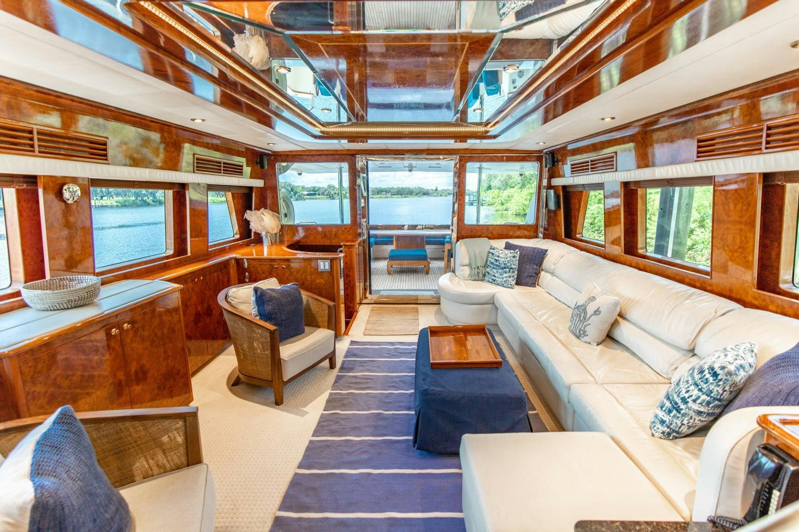 a room with a couch and a table aboard DREAMCHASER Yacht for Sale