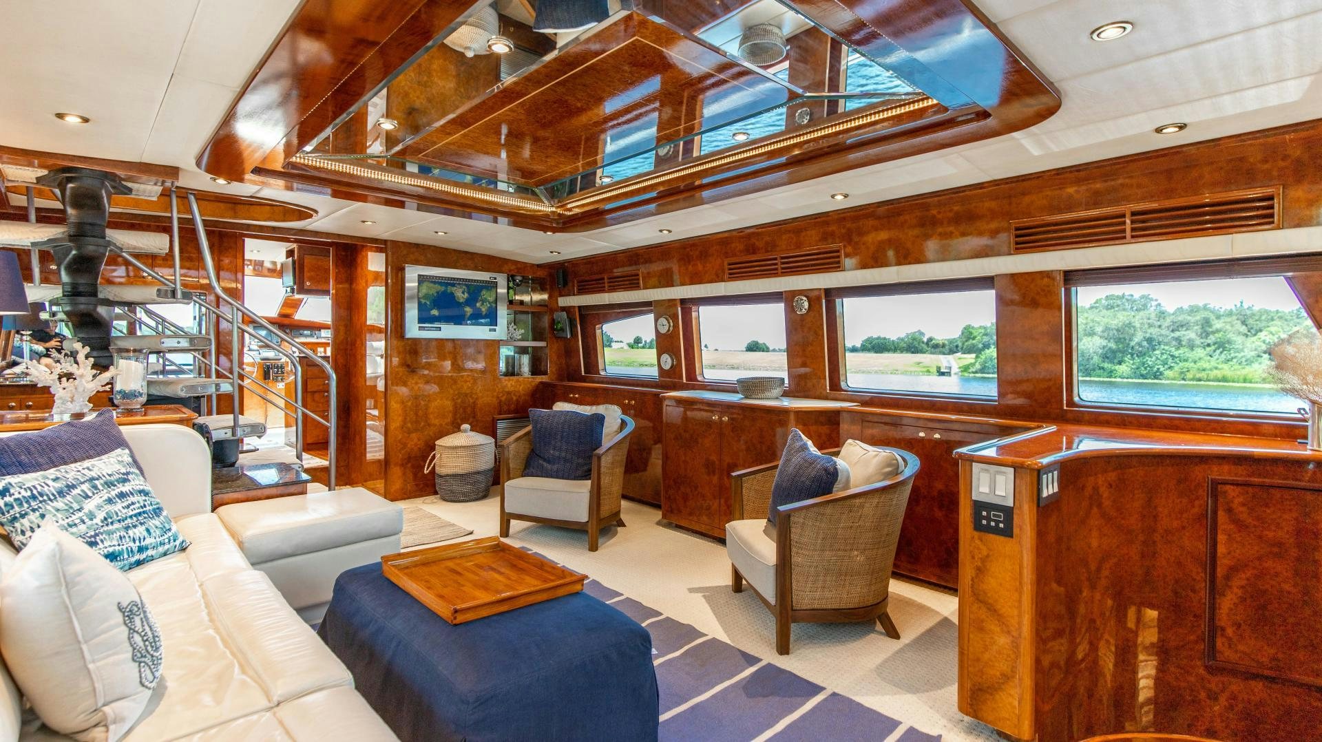 a room with a couch and a chair and a table aboard DREAMCHASER Yacht for Sale