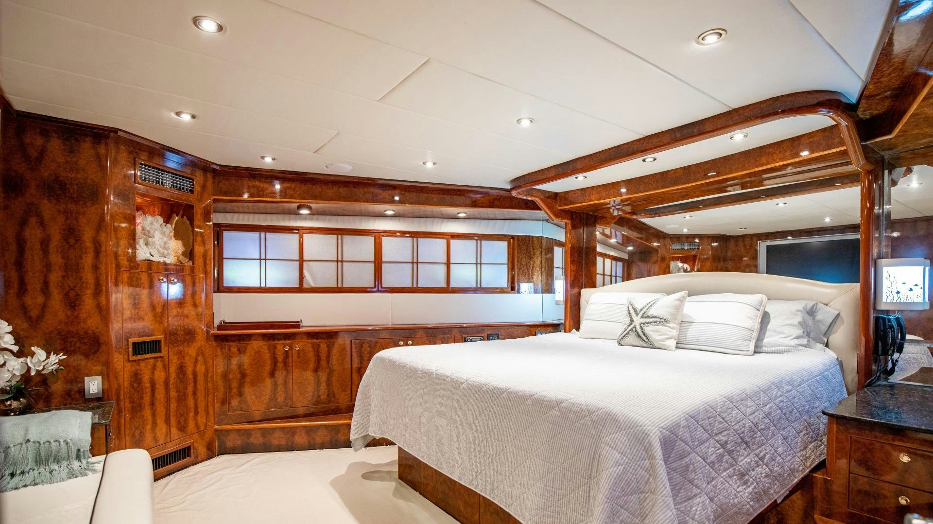 a room with a bed and a wood wall aboard DREAMCHASER Yacht for Sale