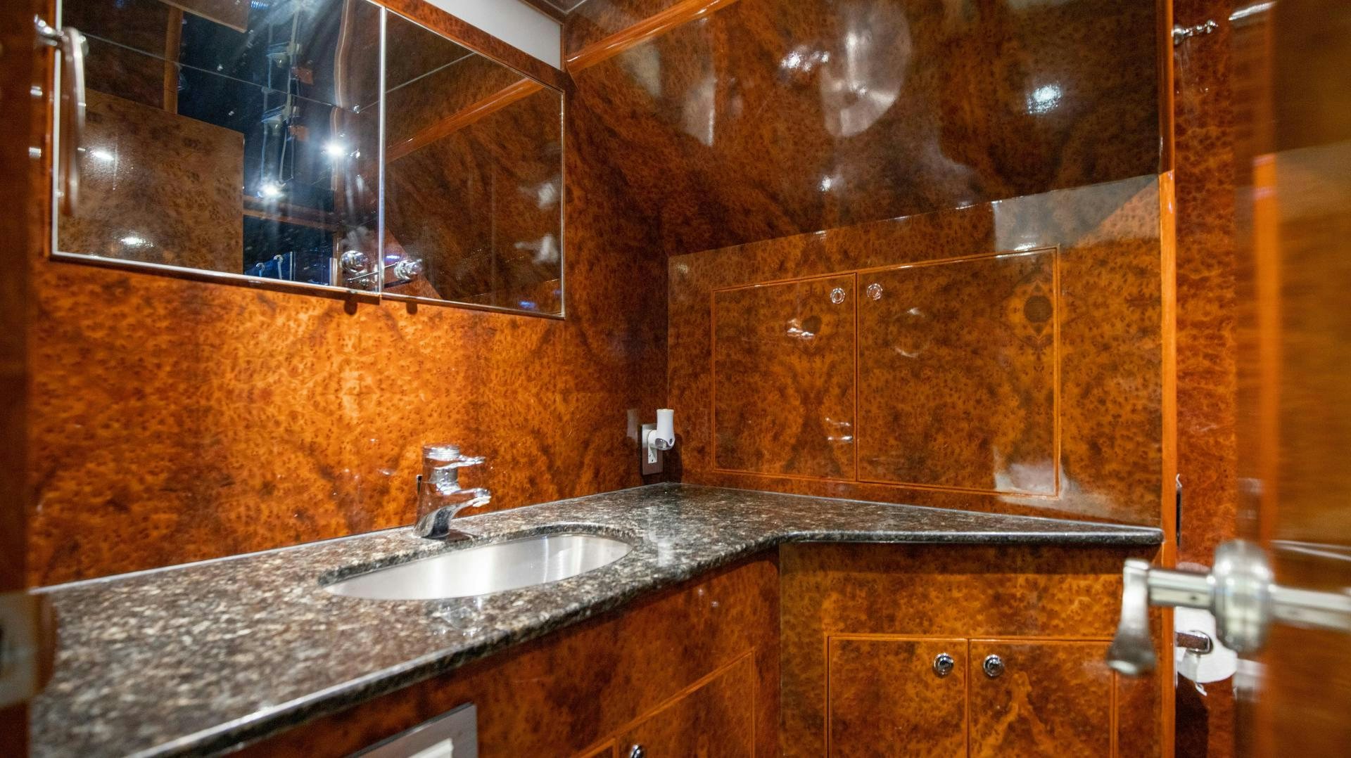 a bathroom with a countertop sink and a large mirror aboard DREAMCHASER Yacht for Sale