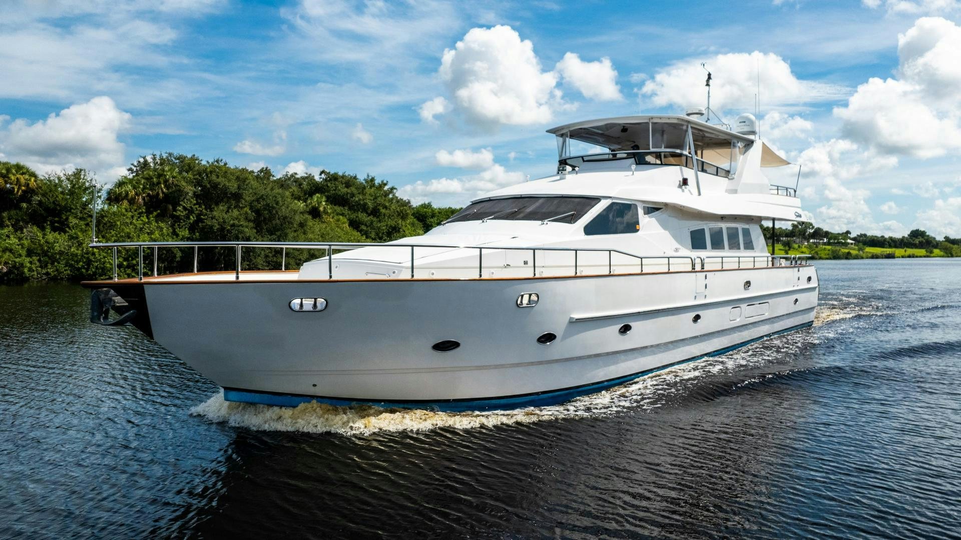 a white boat on water aboard DREAMCHASER Yacht for Sale