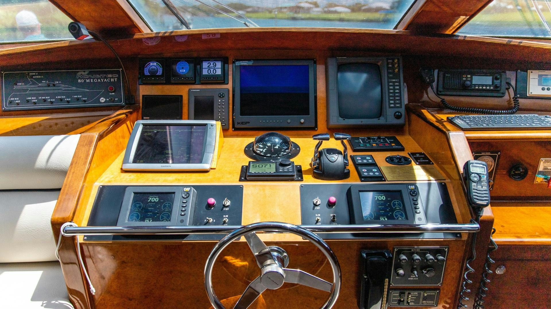 a table with a laptop and a monitor on it aboard DREAMCHASER Yacht for Sale