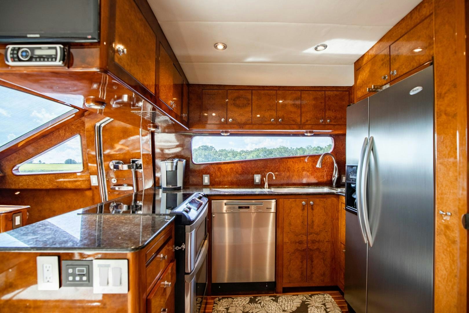 a kitchen with wooden cabinets aboard DREAMCHASER Yacht for Sale